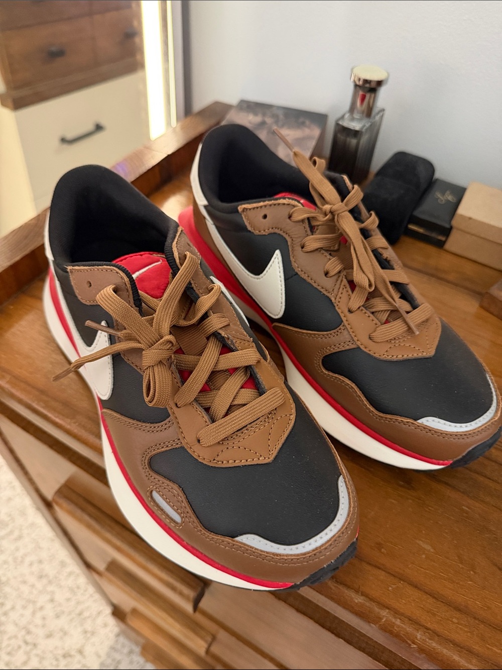 Nike Women's Black and Brown Low-Top Sneakers with White Swoosh and Red Accent